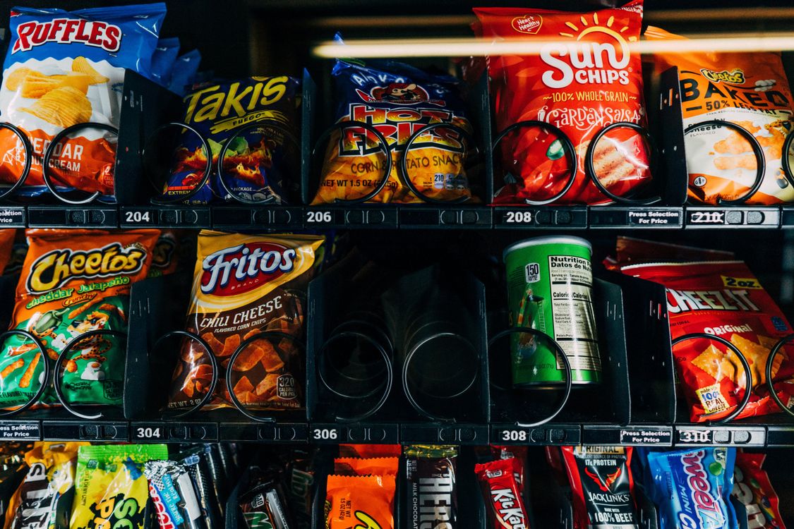 A selection of familiar snacks in a glass-front vending machine